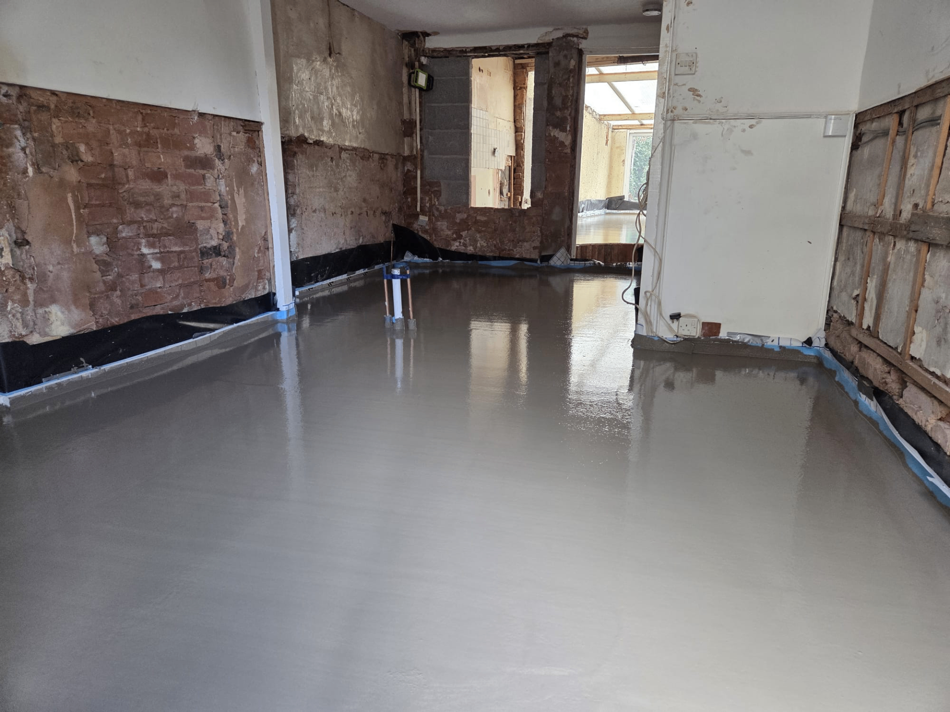 Freshly laid liquid screed floor inside a renovation
